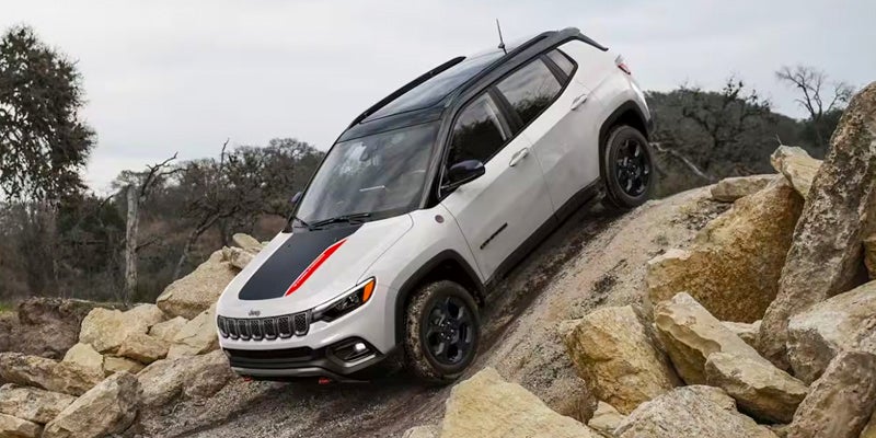 front end of a 2024 Jeep Compass going down over a mountain