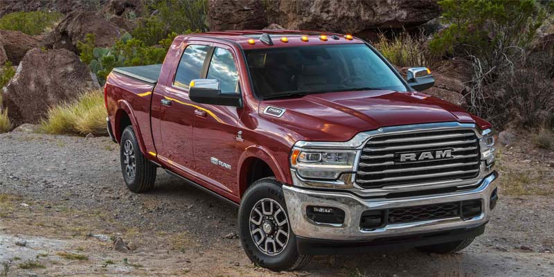 a red 2024 Ram 2500 parked on a dirt road